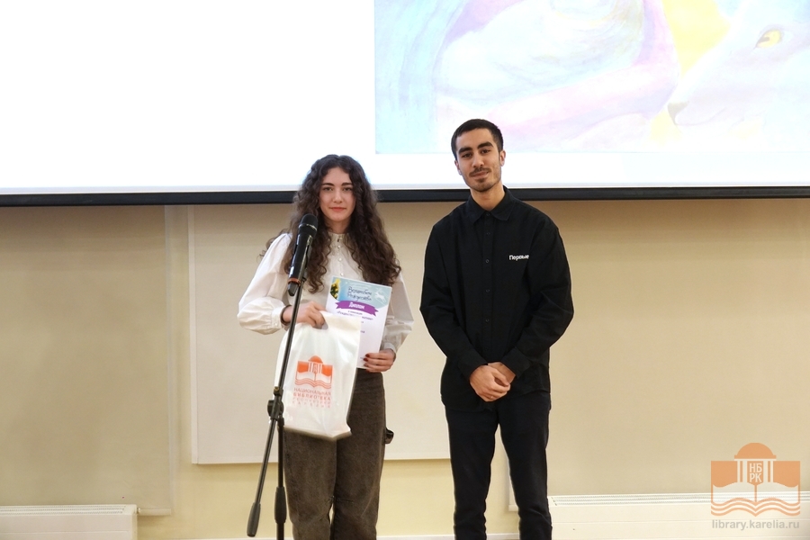 The award is being presented by Ayman Amer, Chairman of Petrozavodsk Branch of the Movement of the First